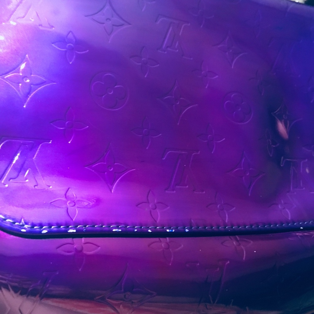Purple Louis Vuitton bag.